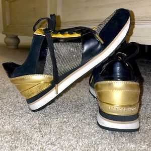 Michael Kors Woman’s Gold & Black sneakers.